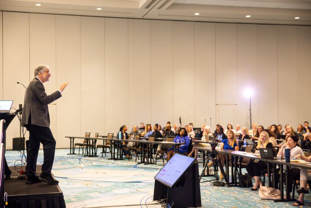 Photo of Jim Spellos speaking at International Association of Administrative Professionals meeting. 