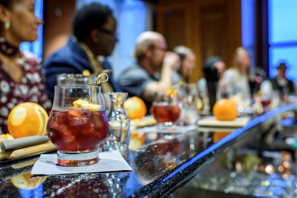 Photo of people sitting at a bar during a bourbon tasting.