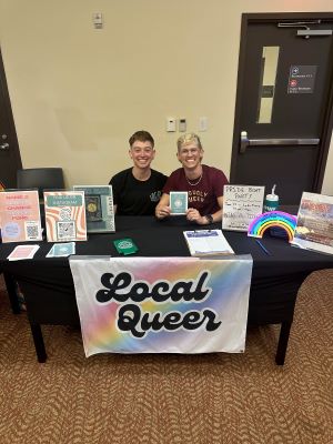 Photo of Chase Brunson sitting at a table representingLocal Queer.