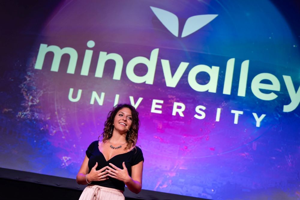 Christy Renee speaking at a Mindvalley University conference