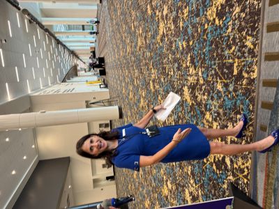 Photo of Elaine Williams, senior director of sales and event services, New Orleans Ernest N. Morial Convention Center, leading a tour and showing the facility's  new carpet.