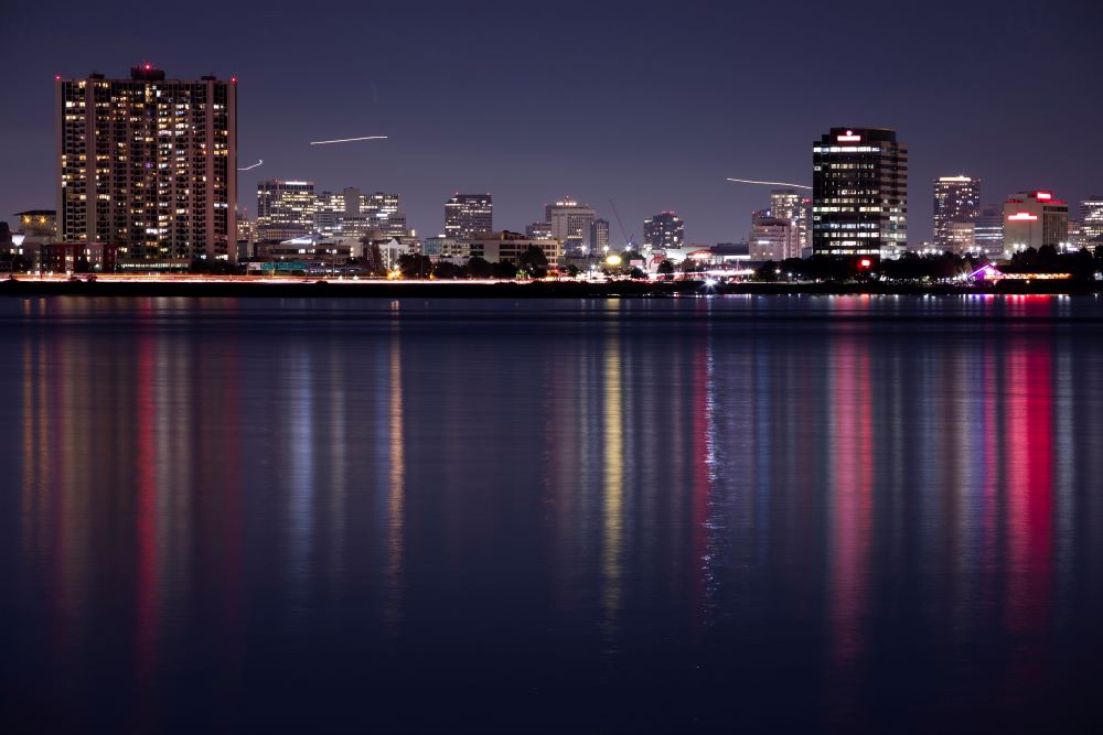 Photo of Emeryville, California skyline at night from San Francisco Bay.