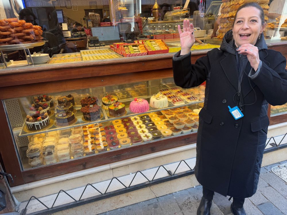 Photo of a tour guide in front of a candy display.