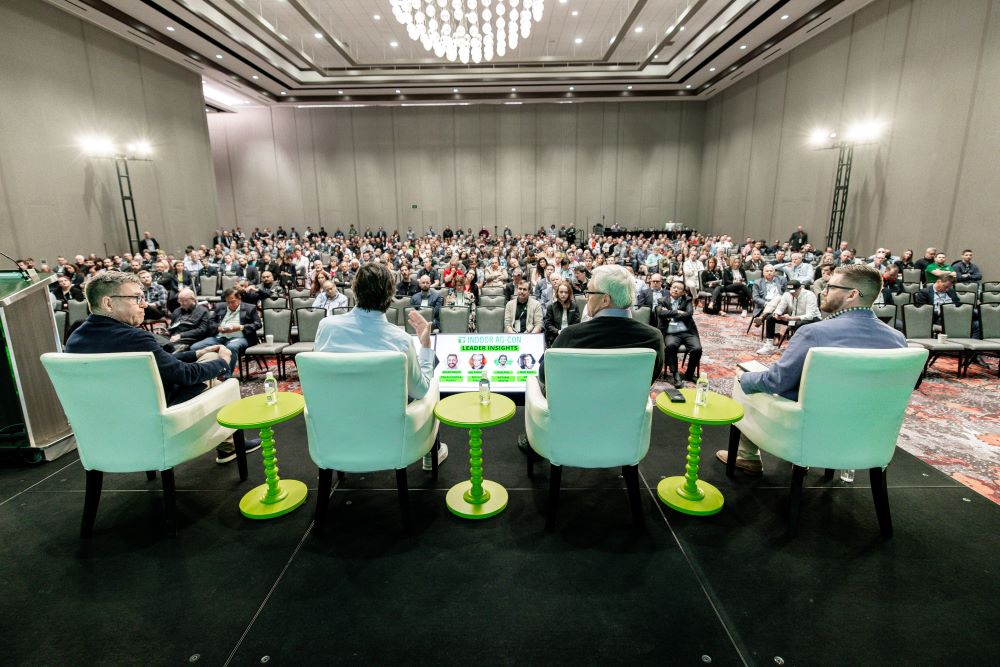 Photo of panelists sitting in green seats at Indoor Ag-Con.