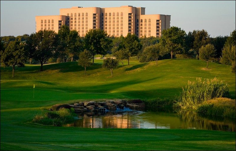 Photo of The Ritz-Carlton Dallas, Las Colinas with a golf course in the foreground.