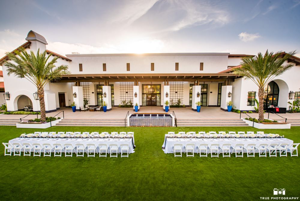 Photo of Luna Lawn set up with two long white tables and chairs.