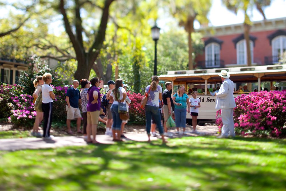 Photo of people standing outside of Mercer Williams House Museum in Savannah.