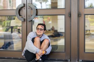 Photo of an actor scared and kneeling in front of a door at Orange County Convention Center.