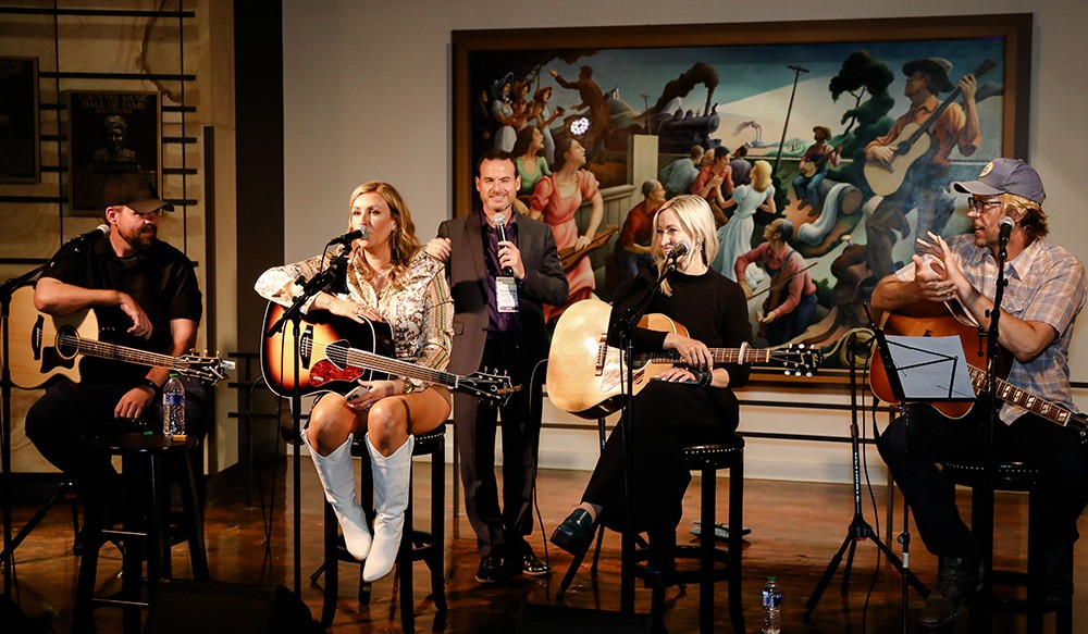 Photo of four singers on stage at Country Music Hall of Fame and Museum.