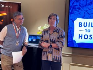 Photo of Samir Mowad and Stephanie Turner speaking in front of a podium.