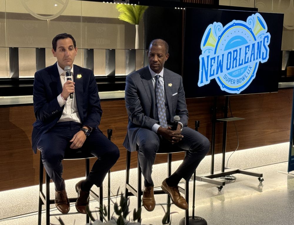 Walt Leger (left) speaking next to a sitting Marcus Brown during a press event.