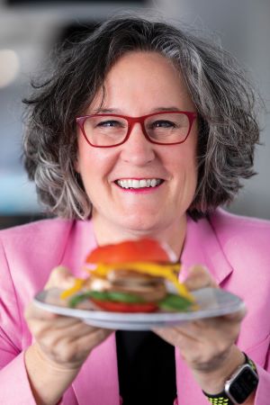 Image of Tracy Stuckrath holding a plate of food. 