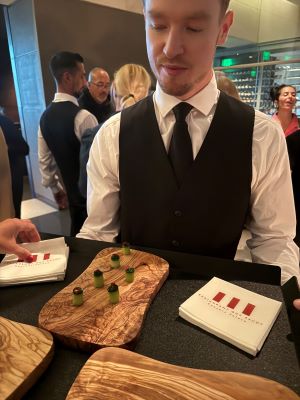 A server at Guy Savoy restaurant shows a platter of hors d'oeuvres. 