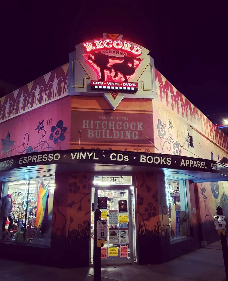 Photo of Record Exchange at night with neon sign.