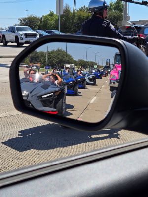 Australian fam participants drive in slingshot vehicles