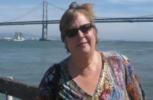 Photo of Maria Lenhart standing in front of the San Francisco Bay Bridge.