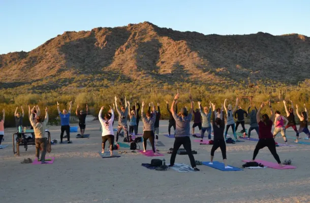 Group practicing yoga at sunset in Phoenix