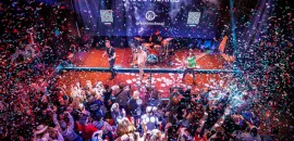 Photo of packed room with celebrants and confetti at Friends in Low Places honky-tonk.
