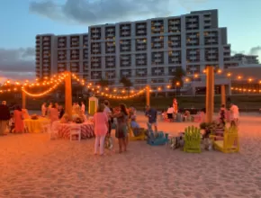 Event setup on the beach with twinkle lights in front of Fort Lauderdale Marriott Harbor Beach Resort & Spa 