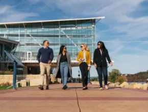 four people walking along Dubuque, Iowa's riverwalk