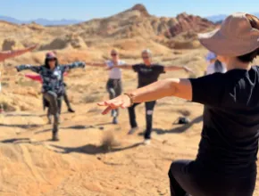 Photo of Dami Kim from the Las Vegas branch of Body & Brain leading an exercise program in Valley of Fire State Park.