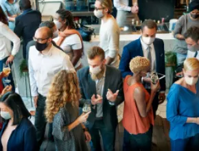 People in Masks Networking at a Business Event