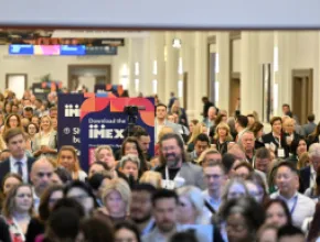 Photo of a large number of people walking into IMEX America 2023.