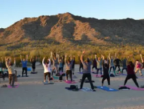 Group practicing yoga at sunset in Phoenix