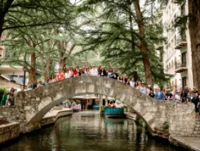 Photo of Meetings Today LIVE! attendees standing on The Selena Bridge on the San Antonio River Walk.