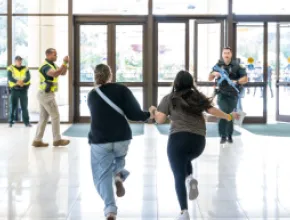 Photo of two people running during a security exercise at Orange County Convention Center.