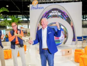 Mike Waterman cutting the ribbon on Visit Anaheim's new tradeshow booth at IPW.