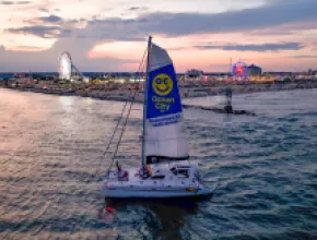 Ocean City sailboat in front of shoreline. Credit: Ocean City