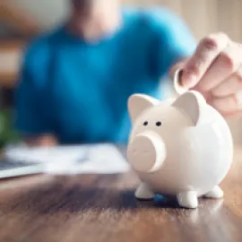 Saving money into a piggy bank