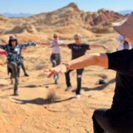 Photo of Dami Kim from the Las Vegas branch of Body & Brain leading an exercise program in Valley of Fire State Park.