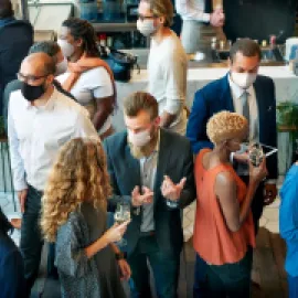 People in Masks Networking at a Business Event