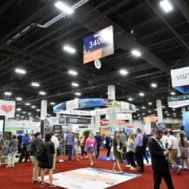 Photo of group of people on the exhibit floor at IMEX America 2023.