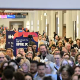 Photo of a large number of people walking into IMEX America 2023.