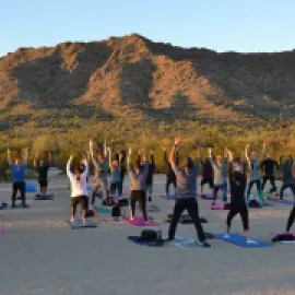 Group practicing yoga at sunset in Phoenix