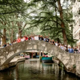 Photo of Meetings Today LIVE! attendees standing on The Selena Bridge on the San Antonio River Walk.