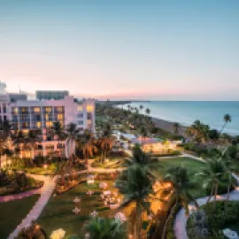 Aerial photo of Wyndham Grand Rio Mar Rainforest Beach and Golf Resort with Caribbean in the background.