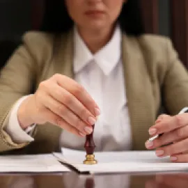 Image of a woman stamping a contract.