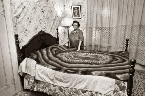 Al Rendón’s Tia Lupe with Virgin de Guadalupe bedspread