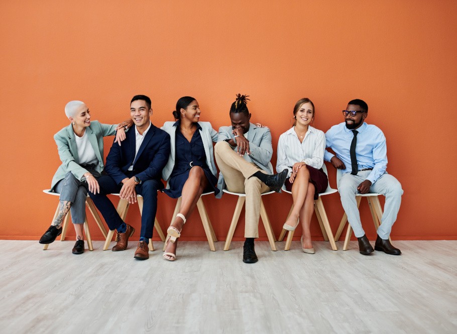 Group of people sitting in a row.