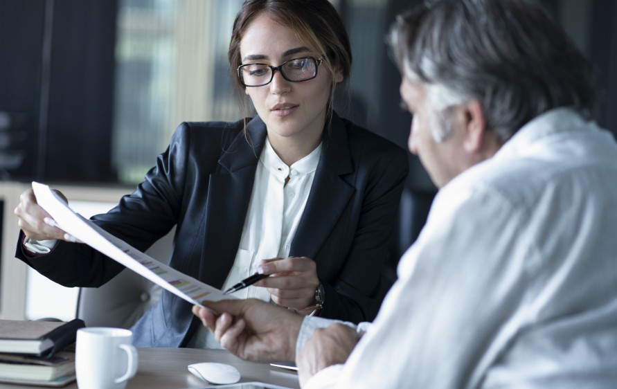 A man and woman reviewing a contract.