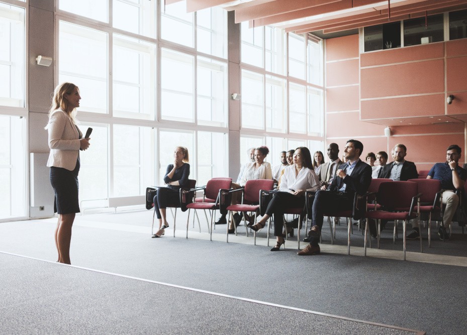 A woman talking to a room of seated people