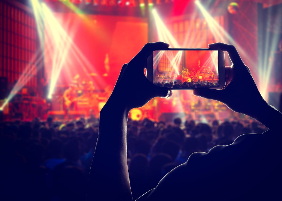 Someone recording a concert with a phone.