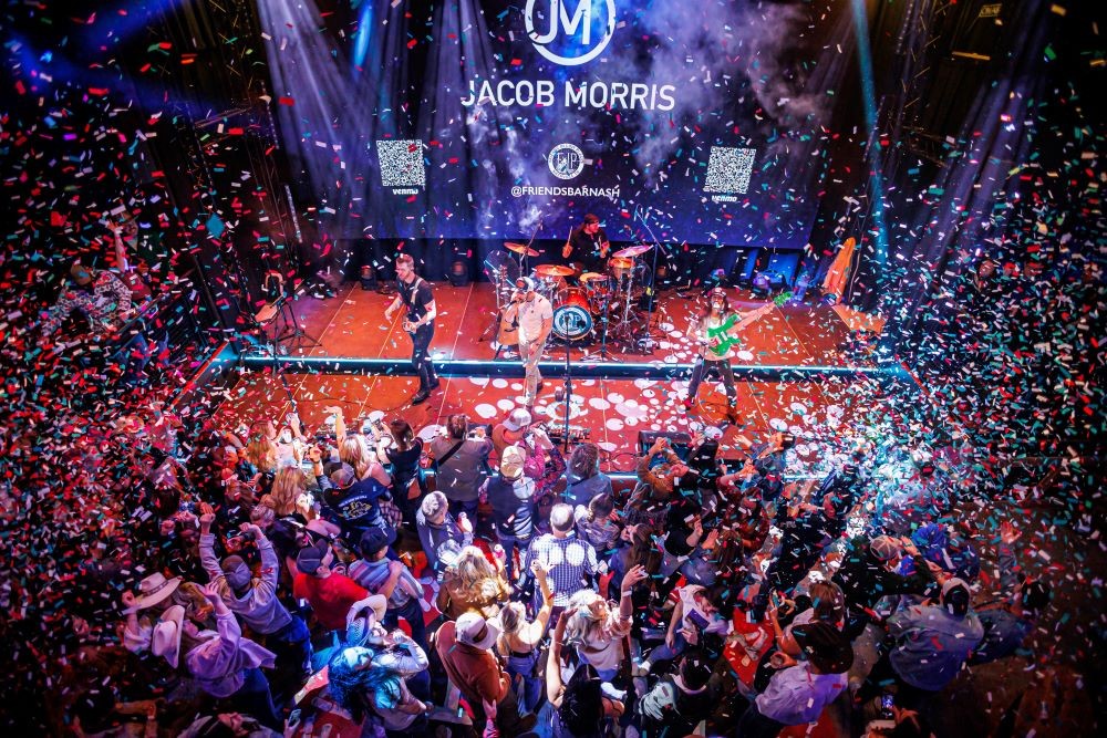 Photo of packed room with celebrants and confetti at Friends in Low Places honky-tonk.