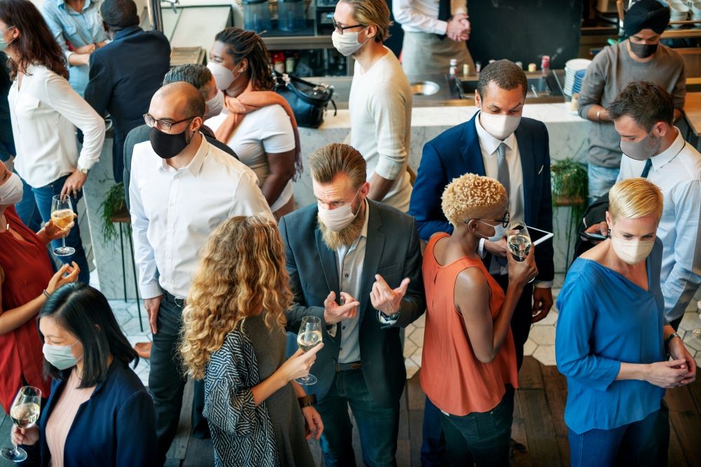 People in Masks Networking at a Business Event