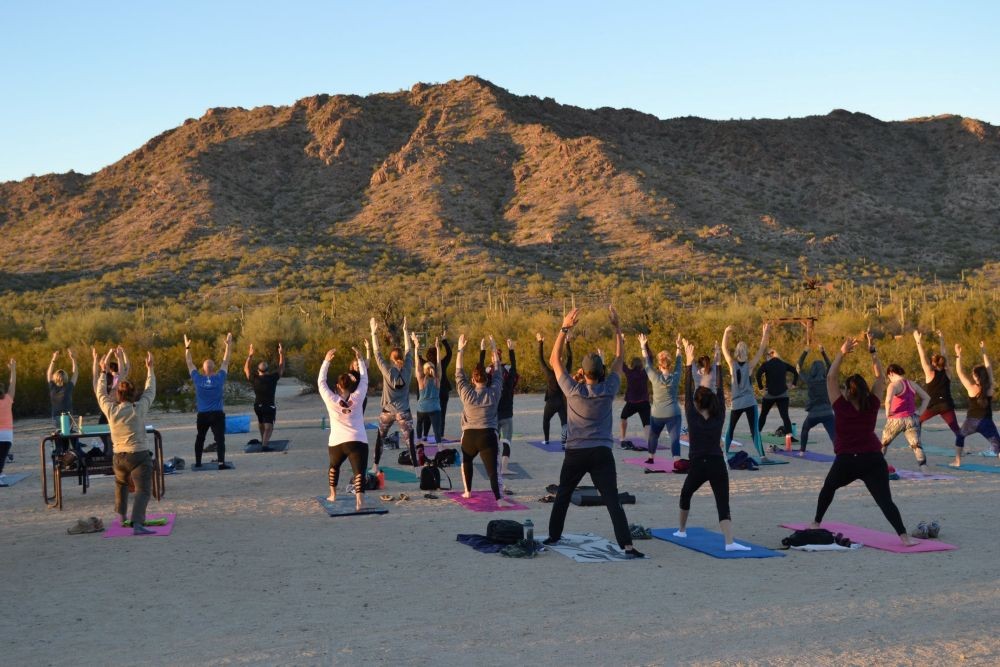 Group practicing yoga at sunset in Phoenix