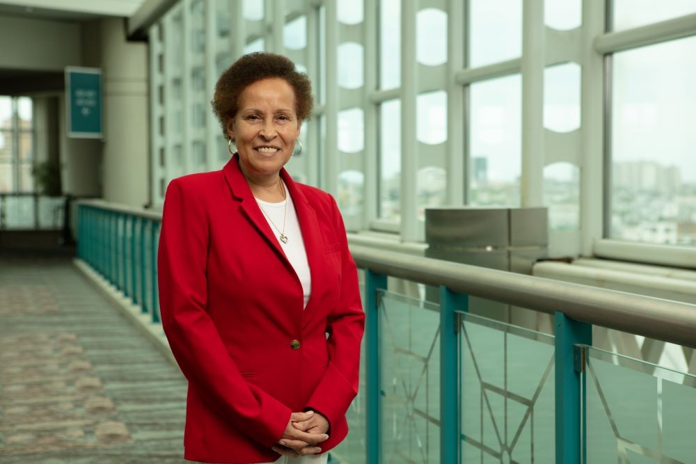 Photo of Sandi Harvey standing in a red jacket in the Atlantic City Convention Center.